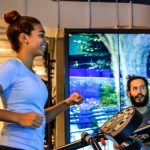 Woman Smiling in front of RPV display in Nike Soho