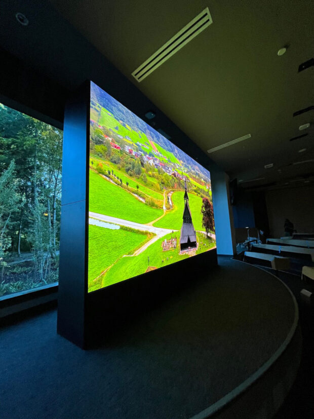 floor to ceiling visual structure with visuals of a landscape on the screen