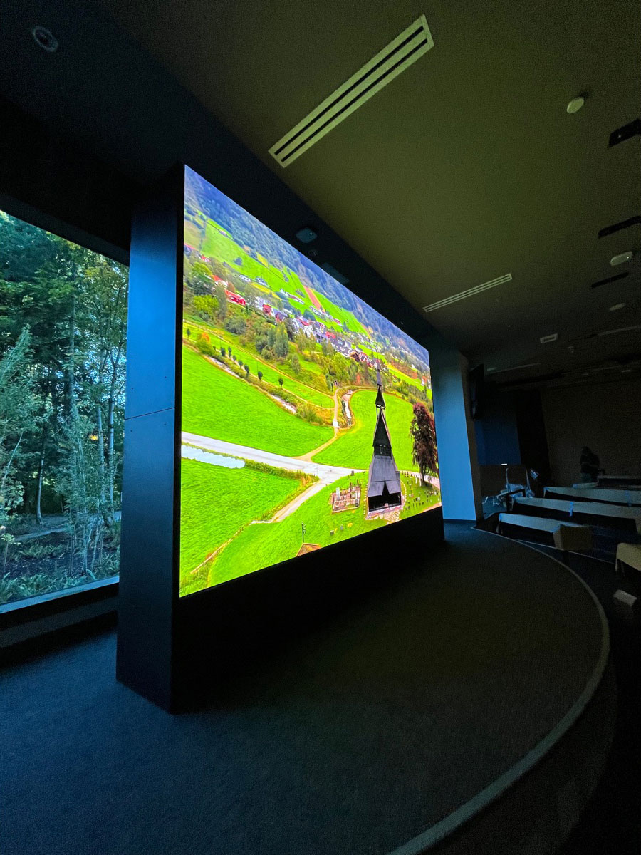 floor to ceiling visual structure with visuals of a landscape on the screen