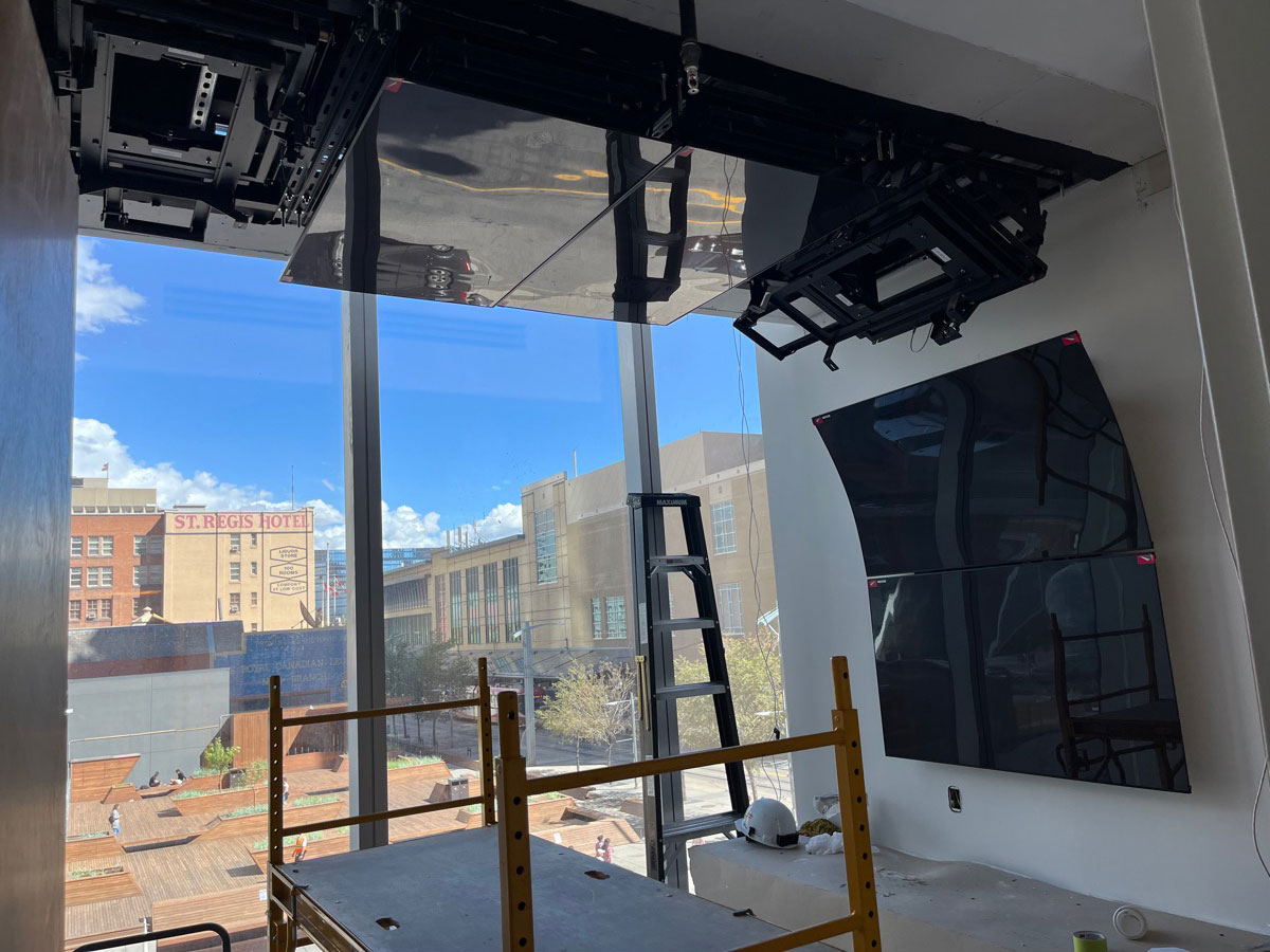In progress photo of ceiling to wall custom mount with displays installed