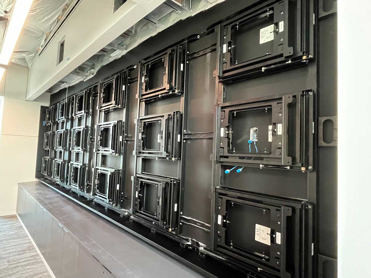 Side view of custom 6w x 3h wall attached visual structure to support eighteen 55in displays in landscape using an RPV swing mount solution (in progress)