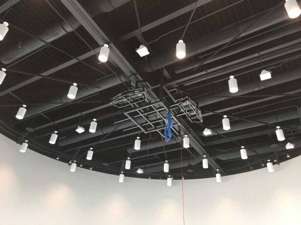 In progress photo of a ceiling suspended truss system with drawer slide service provisions for 8 projections (full view)