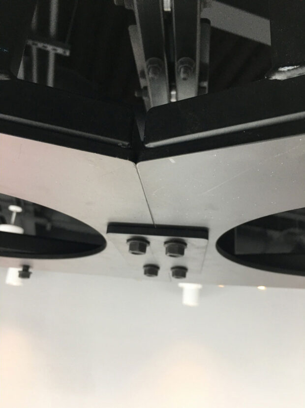 In progress photo of a ceiling suspended truss system with drawer slide service provisions for 8 projections (close up of truss)