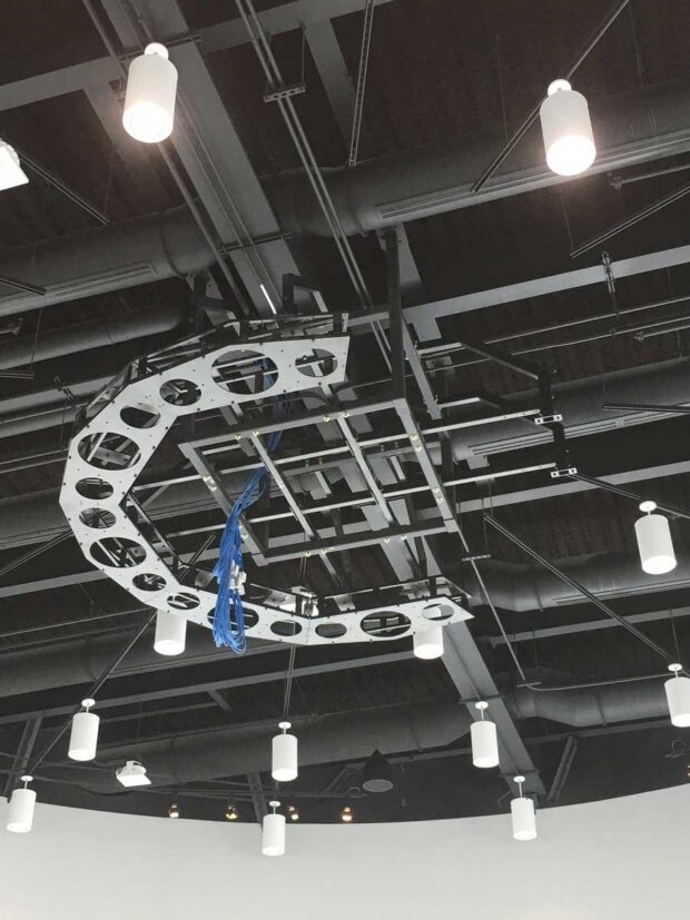 In progress photo of a ceiling suspended truss system with drawer slide service provisions for 8 projections (center view)